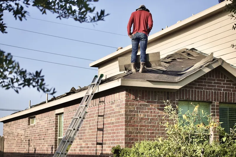 Professional roofer working on a residential roof in Gonzalez